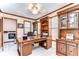 Office with built-in wood shelving, a ceiling fan, natural light, and white tile flooring at 16349 Spring Valley Rd, Dade City, FL 33523