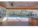 Screened-in pool area featuring a hot tub and spacious outdoor living space at 16349 Spring Valley Rd, Dade City, FL 33523