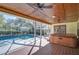 Screened-in pool area includes a hot tub with a wooden ceiling, and a view of the backyard at 16349 Spring Valley Rd, Dade City, FL 33523