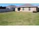 Well-maintained back yard features a lush lawn and a neutral-toned privacy fence for outdoor enjoyment at 17152 Sunshine Mimosa St, Wimauma, FL 33598