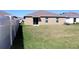 The large back yard of this house is completely fenced with a well manicured lawn at 17152 Sunshine Mimosa St, Wimauma, FL 33598
