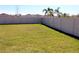 Large backyard with a privacy fence and lush green grass at 17152 Sunshine Mimosa St, Wimauma, FL 33598