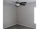 A cozy bedroom featuring gray walls, a ceiling fan, carpeted floor, and a window for natural light at 17152 Sunshine Mimosa St, Wimauma, FL 33598