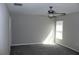 Bright bedroom featuring a ceiling fan and window with natural light at 17152 Sunshine Mimosa St, Wimauma, FL 33598