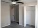 A cozy bedroom featuring gray walls, a ceiling fan, carpeted floor, and a window for natural light and closet at 17152 Sunshine Mimosa St, Wimauma, FL 33598