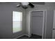 A cozy bedroom featuring gray walls, a ceiling fan, carpeted floor, a window for natural light, and a closet at 17152 Sunshine Mimosa St, Wimauma, FL 33598