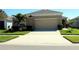 Charming single-story home featuring well-maintained landscaping and an attached two-car garage with a wide concrete driveway at 17152 Sunshine Mimosa St, Wimauma, FL 33598