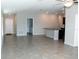 Bright, open-concept living space with tile floors and natural light, flowing into the kitchen area at 17152 Sunshine Mimosa St, Wimauma, FL 33598