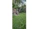 Overgrown backyard with a partial brick BBQ pit at 1743 Maryland Ne Ave, St Petersburg, FL 33703