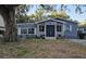 Charming single-story home featuring a gray exterior with white trim and a well-maintained front yard at 1743 Maryland Ne Ave, St Petersburg, FL 33703