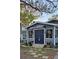 Welcoming home featuring a manicured lawn, complemented by colorful potted plants near the entrance at 1743 Maryland Ne Ave, St Petersburg, FL 33703