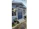 Charming home featuring a blue double-door entry, decorative plants, and a protective awning at 1743 Maryland Ne Ave, St Petersburg, FL 33703