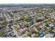 An aerial shot shows a residential neighborhood with swimming pools and lush trees, offering a comfortable living environment at 1863 Alberta Dr, Largo, FL 33756