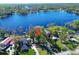 Stunning aerial view capturing the home's location, lush landscaping, waterfront access, and dock at 18715 Lakeshore Dr, Lutz, FL 33549