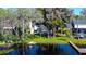 Aerial view showcasing the home's backyard with lake access, docks, and surrounding lush landscape at 18715 Lakeshore Dr, Lutz, FL 33549