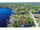 Beautiful aerial shot featuring the property near the lake and surrounded by mature trees at 18715 Lakeshore Dr, Lutz, FL 33549