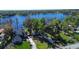 Breathtaking aerial view of lakeside home with mature trees and a private dock at 18715 Lakeshore Dr, Lutz, FL 33549