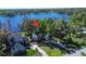 Stunning lakefront property with lush greenery and a charming two-story home nestled among the trees at 18715 Lakeshore Dr, Lutz, FL 33549