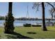 Backyard scene with tire swing, lake views, trees and a dock at 18715 Lakeshore Dr, Lutz, FL 33549