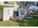 Backyard patio and lawn area with chairs and a shower at 18715 Lakeshore Dr, Lutz, FL 33549