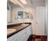 Bathroom featuring double vanity, tile floors, and a large mirror at 18715 Lakeshore Dr, Lutz, FL 33549