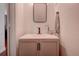 Elegant half-bath with modern sink, stylish mirror, and horizontally tiled wall at 18715 Lakeshore Dr, Lutz, FL 33549