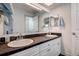 Elegant bathroom featuring double sinks with stylish marble countertops and modern white cabinets at 18715 Lakeshore Dr, Lutz, FL 33549