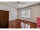 Bright bedroom with hardwood floors, large window and ceiling fan at 18715 Lakeshore Dr, Lutz, FL 33549