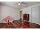 Bedroom with hardwood floors and pink play house at 18715 Lakeshore Dr, Lutz, FL 33549