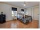 Well-lit bedroom with hardwood floors, ceiling fan, and two large windows at 18715 Lakeshore Dr, Lutz, FL 33549
