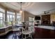 Bright dining room with large windows, a wooden dining table, and a fireplace in the living room at 18715 Lakeshore Dr, Lutz, FL 33549