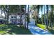 Well-maintained home with a two-car garage, mature landscaping and gray brick paver driveway at 18715 Lakeshore Dr, Lutz, FL 33549