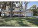 Charming two-story home with a welcoming front porch, well-manicured lawn, and attached two-car garage at 18715 Lakeshore Dr, Lutz, FL 33549