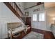 Inviting foyer with hardwood floors, staircase, decorative wainscoting, and bench at 18715 Lakeshore Dr, Lutz, FL 33549