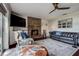 Bright living room includes a brick fireplace, comfortable seating, modern lighting, and a sliding glass door at 18715 Lakeshore Dr, Lutz, FL 33549