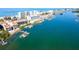 An aerial view showcases waterfront living with boat docks and easy access to the Gulf at 19937 Gulf Blvd # B-3, Indian Shores, FL 33785