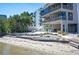 Lovely backyard with a patio, lounge chairs, and mature trees for the ultimate outdoor enjoyment at 19937 Gulf Blvd # B-3, Indian Shores, FL 33785