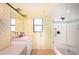 Bright bathroom featuring double vanity, granite counters, and a glass enclosed shower at 19937 Gulf Blvd # B-3, Indian Shores, FL 33785