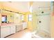Bright bathroom with double vanity, a glass enclosed shower, and contemporary finishes at 19937 Gulf Blvd # B-3, Indian Shores, FL 33785