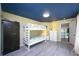 Bright bedroom featuring bunk beds with easy access to the hallway and a bright window at 19937 Gulf Blvd # B-3, Indian Shores, FL 33785