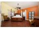 Spacious bedroom features a four-poster bed, ceiling fan and bright natural light at 19937 Gulf Blvd # B-3, Indian Shores, FL 33785