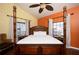 Comfortable bedroom with a four-poster bed, ceiling fan, and natural light at 19937 Gulf Blvd # B-3, Indian Shores, FL 33785