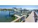 Well maintained boat dock with boat lifts, safety signage, and clear waterfront views at 19937 Gulf Blvd # B-3, Indian Shores, FL 33785