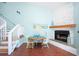Dining area with seaside decor alongside a stone fireplace and a staircase, bathed in natural light at 19937 Gulf Blvd # B-3, Indian Shores, FL 33785