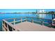 Dock with beautiful water view featuring a painted wood deck and protective safety railing at 19937 Gulf Blvd # B-3, Indian Shores, FL 33785