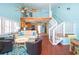 Inviting living room features high ceilings, a staircase to a loft, and an adjacent modern kitchen at 19937 Gulf Blvd # B-3, Indian Shores, FL 33785