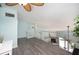 Bright open living space with updated flooring, ceiling fan, and glass railing overlooking the living area below at 19937 Gulf Blvd # B-3, Indian Shores, FL 33785