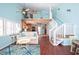 Cozy living room features high ceilings, access to a loft, and an adjacent modern kitchen at 19937 Gulf Blvd # B-3, Indian Shores, FL 33785