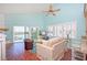 Bright living room features modern furnishings, a ceiling fan, and access to an outdoor balcony at 19937 Gulf Blvd # B-3, Indian Shores, FL 33785