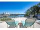 Charming outdoor patio featuring lounge chairs, BBQ grills, overlooking the water at 19937 Gulf Blvd # B-3, Indian Shores, FL 33785
